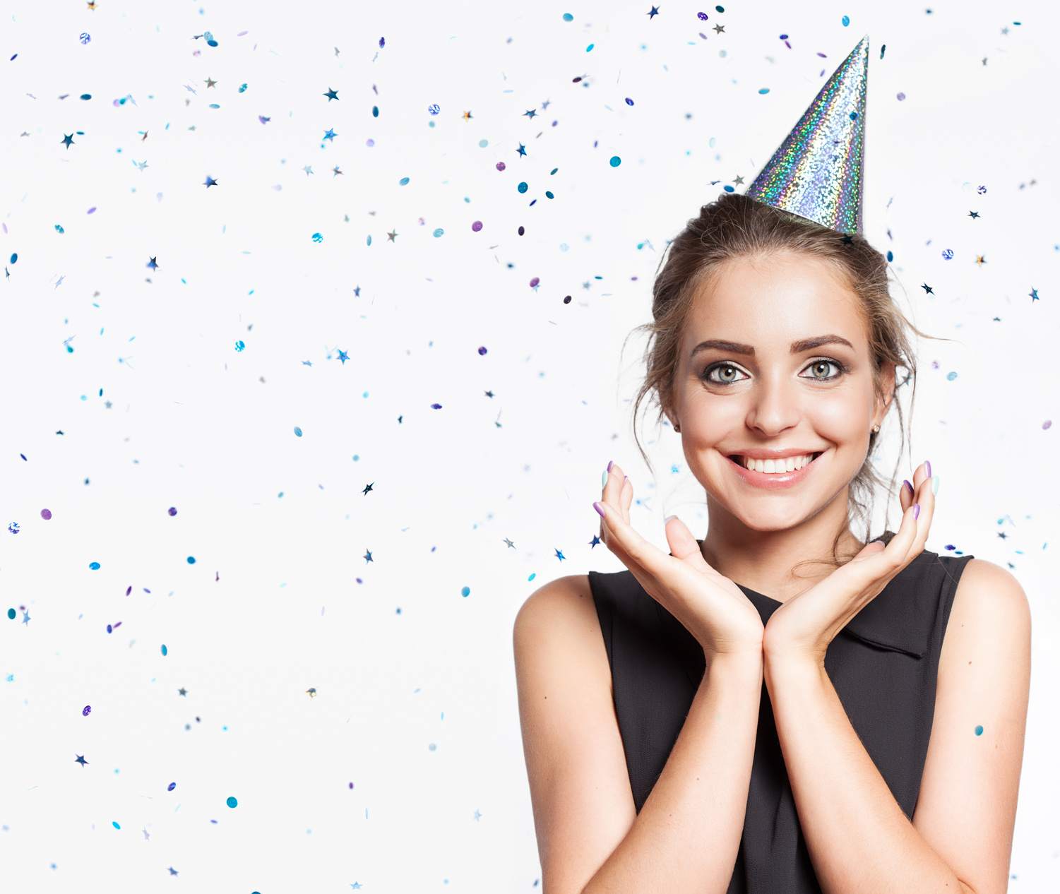 Woman on the background of shiny confetti from the free space on the left